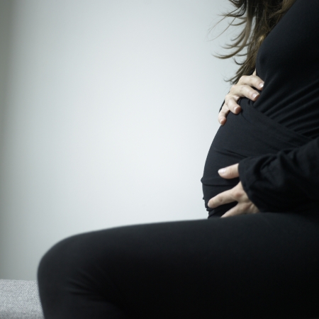 Belly of a pregant woman wearing black