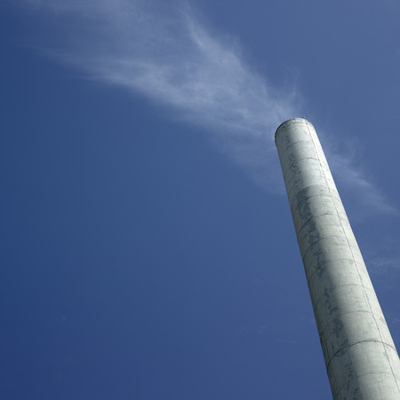 Tall chimney against blue skyの写真素材