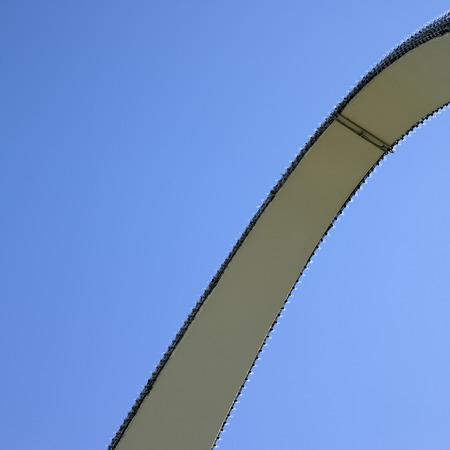 Arch with clear lightbulbs against blue skyの写真素材