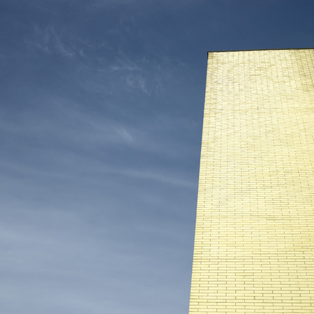 Gold brick building against blue skyの写真素材