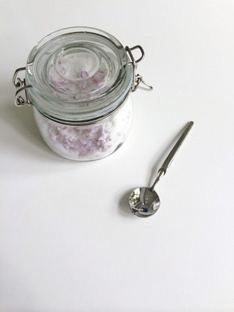 Glass jar of granulated white sugar and lilac flowersの写真素材