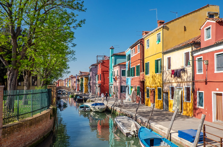 Colourfully painted houses along canal in island Burano in the Venetian Lagoon namedの写真素材