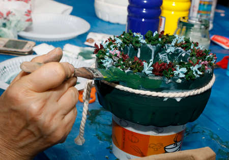 Hand of florist making a succulent plant in pottery workshop