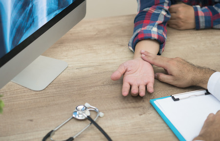 Doctor diagnose pulse of patient