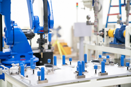 Industrial automated robot arm holding car glass in factoryの写真素材