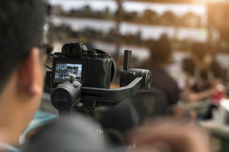 Video camera man operator working with professional equipment,filming recording