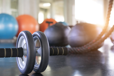 Close up of a fitness equipment in gym. Exercise wheel in a gym. Fitness roller equipment. Selective focus.の写真素材