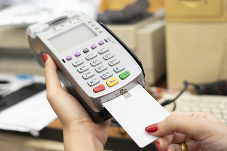 Moment of payment with a credit card through terminal.monochrome.
