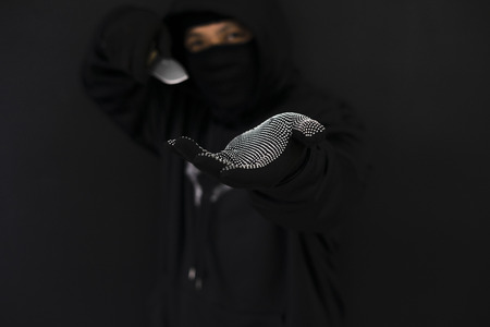 Robber with big knife - a killer person with sharp knife about to commit a homicide, murder scenery.の写真素材
