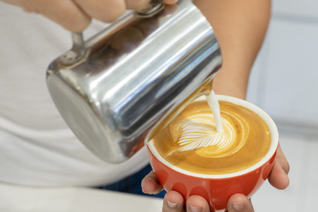 how to make latte art by barista focus in milk and coffee in vintage colorの写真素材