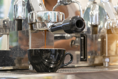 Close-up of espresso pouring from coffee machine. Professional coffee brewingの写真素材