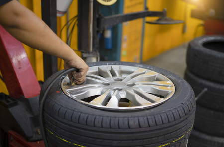 Filling air into a car tireの写真素材