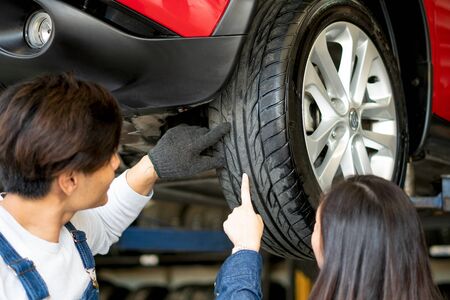 Technicians professional advice on the use of tire. To female customersの写真素材