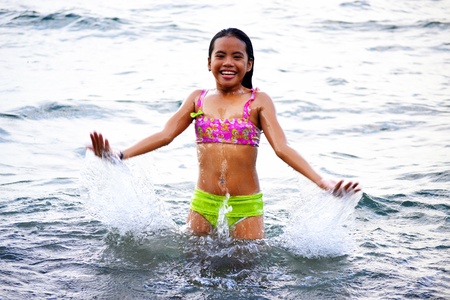 Cute Asian girl enjoying the great water during summerの写真素材