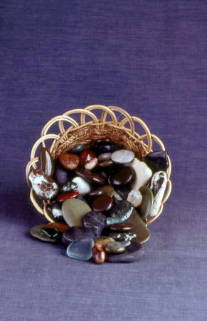 Polished rocks in basket .の写真素材