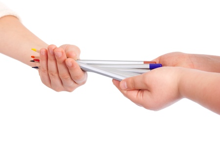 Pencils in a hands of the children on the whiteの写真素材