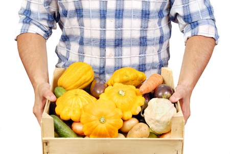 Man holds a box with vegetables. Isolated over whiteの写真素材