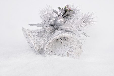 Hand bells for a Christmas decoration in snowの写真素材