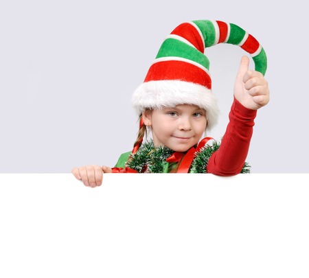 Girl - Santa's elf showing sign OK with the bannerの写真素材