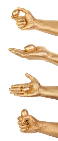 Set from 4 Gold Eggs in a gold man's hand. Isolated on white. Business success concept symbols.の写真素材