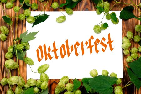 Wooden Board With Sheet And Lettering Oktoberfest, Frame Of Green Hop.の写真素材