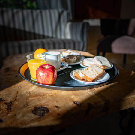 Breakfast with coffee, orange juice and bread on a wooden tableの写真素材