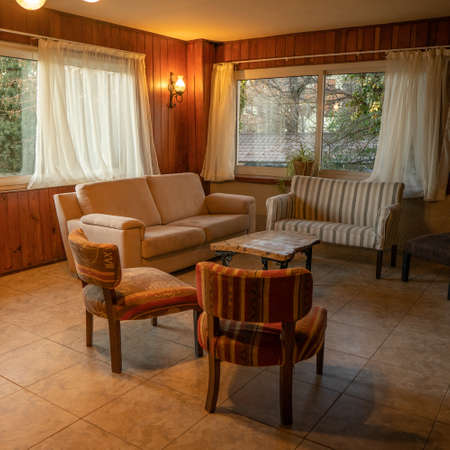Interior of a country house living room with armchairs and sofaの写真素材
