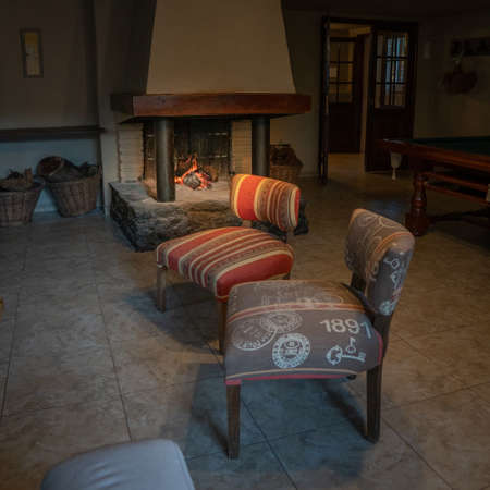 Interior of a medieval house with fireplace and armchairs, Polandの写真素材