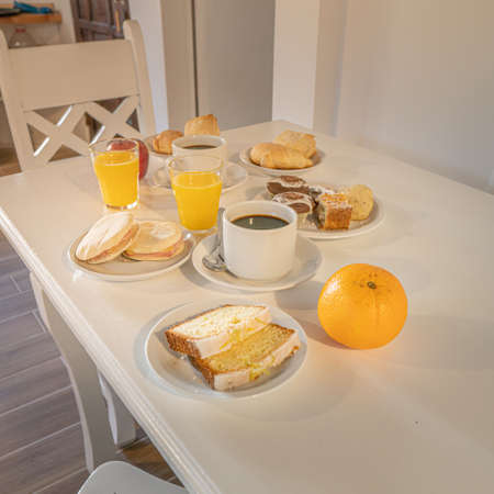 Breakfast with coffee, orange juice and croissants on the tableの写真素材