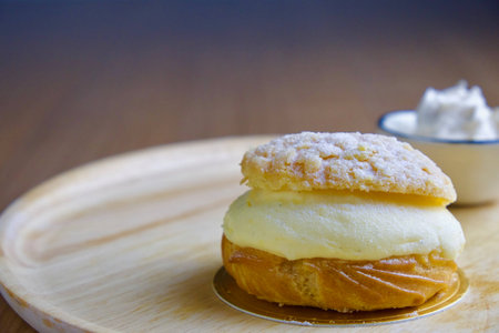 Cream puff topped with sugar powderの写真素材