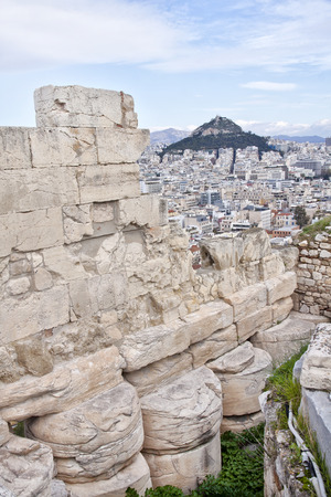 View from the Acropolis to the Athens suburb. On the background could see mount Lycabettus , also known as Lycabettos, Lykabettos or Lykavittos. It  is a Cretaceous limestone hill in Athens, Greece at 300 meters 908 feet above sea level. Pine trees cover の写真素材
