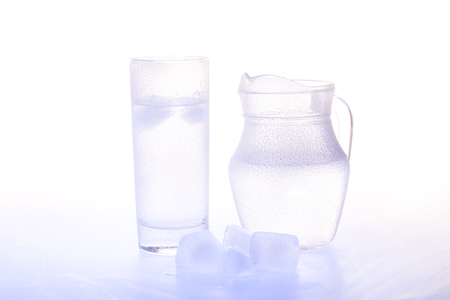 Studio picture of Jug and glass with ice waterの写真素材