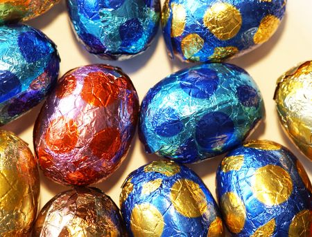 Background of colorful chocolate eggs wrapped in foil                   