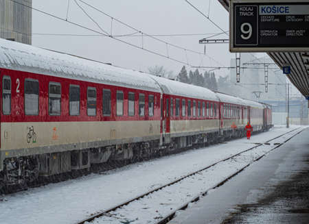 Red train at the station in the winter.の写真素材
