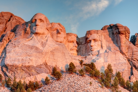 Mount Rushmore National Memorial on a clear blue sunny morning during sunrise showing all four presidents faces in HDR のeditorial素材