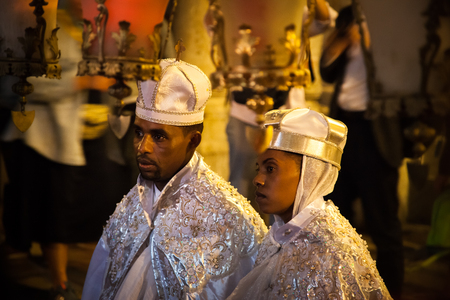 JERUSALEM / ISRAEL - NOVEMBER 19, 2016: Black couple get married in white clothes inside Church of...