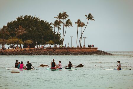 HONOLULU, HAWAII/USA â MAY 28, 2018: Paddle boarders in the harbor wait for the lantern floating ceremony at Ala Moana Beach Park on Magic Island in downtown Honolulu, Oahu, Hawaii, USA.のeditorial素材