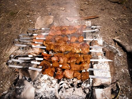 Grilled kebab cooking on metal skewer. Roasted meat cooked at barbecue. BBQ fresh beef meat chop slices. Traditional eastern dish, shish kebabの写真素材
