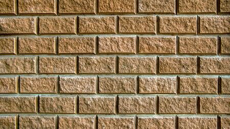Yellow clean brick wall a photo close-up . Beautiful texture. Background from the wall of yellow...