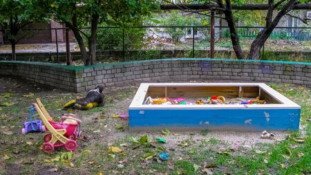 Toys left by children in a panic in the quarantine zone on the playground. The consequences of a viral attack. Playground without children.の写真素材