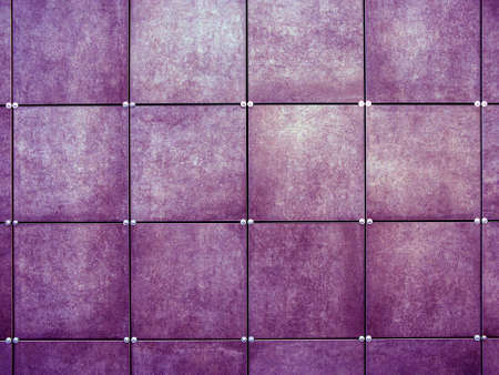 The wall is covered with purple square tiles. Modern wall design. Exterior decoration of the walls of the house and external facades with siding.の写真素材