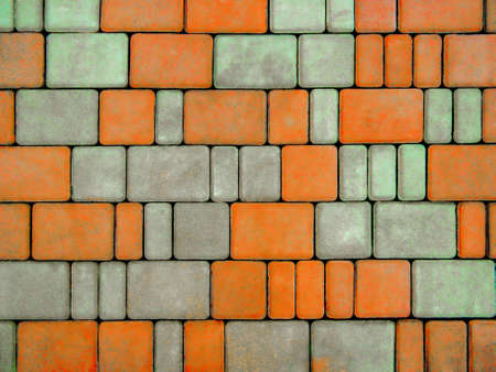 Background stone paving slabs. The texture of the earth with brickwork on the sidewalk. Beautiful rectangular multi-colored stone tiles for walkways and streets.の写真素材