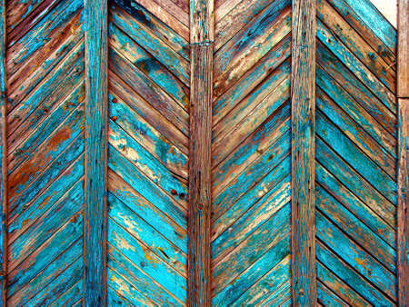 Background of brown wooden fence made of planks. The texture of an old rustic wooden fence made Background of blue wooden fence made of planks. The texture of an old rustic wooden fence made of flat processed boards. Wooden fence made of old boards with the inclusion of knots. Background design.の写真素材