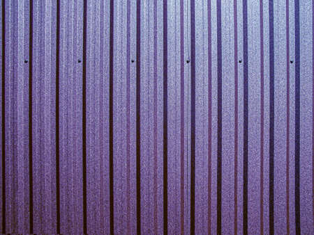 Background of blue corrugated metal sheet. Modern technologies in construction. Metal tiles. Reliable, modern metal materials.の写真素材