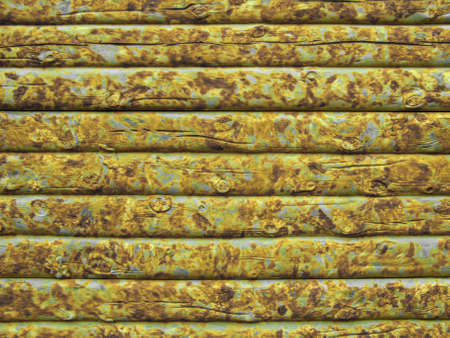 Background from a yellow wooden fence made of boards. The texture of a new rustic wooden fence made of flat processed boards. Wooden fence made of old boards with the inclusion of knots. Background design.の写真素材