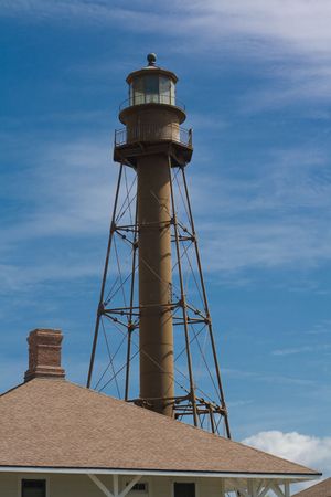 Steel framed lighthouse in Sanibel Florida with Keeper's Roof, and an osprey on the lighthouse railingの写真素材