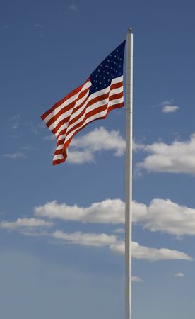 US Flag against  blue sky with clouds  background