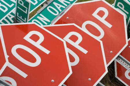 Stop signs piled up on a construction siteの写真素材