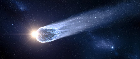 A magnificent comet travels through the dark expanse of space, glowing brightly as it leaves a trail of cosmic dust, creating a breathtaking celestial displayの素材