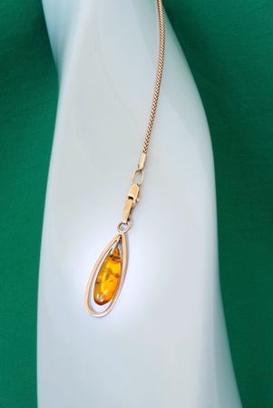 Amber pendant with golden chainの写真素材